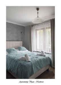 Postel nebo postele na pokoji v ubytování Vigan Apartamenty