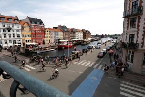 a group of people walking and riding bikes on a city street at Hotel Bethel in Copenhagen