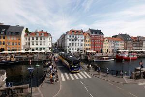 a bus driving down a street in a city with buildings at Hotel Bethel in Copenhagen