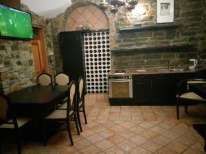 a kitchen with a table and chairs and a sink at Apartments Old Isola in the center in Izola