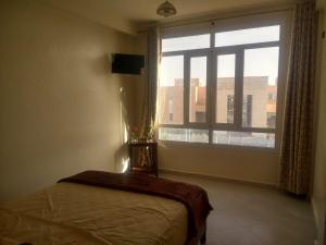 Uma cama ou camas num quarto em Hôtel Afoulki Tiznit