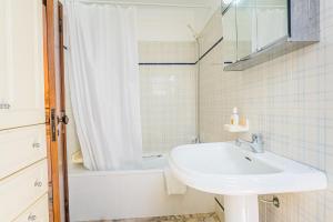 a white bathroom with a sink and a shower at Estrela de Sesimbra in Sesimbra +27 photos