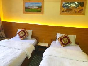 Postel nebo postele na pokoji v ubytování Hotel Pomelo House Inn