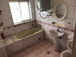 a bathroom with a bath tub and a sink at Yeheng Terrace Homestay in Sanguang +20 photos