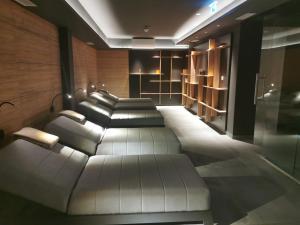 a living room with a white couch and shelves at Hotel Olea in Novalja
