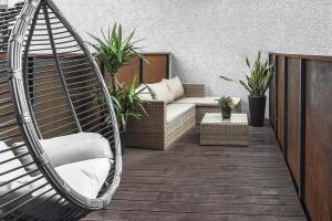 a porch with a hammock and a couch at Four Luxury flats in Kaunas
