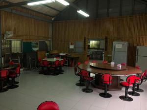 a large room with tables and red chairs at Yeheng Terrace Homestay in Sanguang