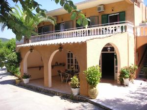 a house with a balcony and a patio at River Studios & Apartments in Mesongi