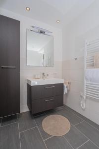 a bathroom with a sink and a mirror at Appartement Schöpf in Längenfeld