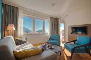 a living room with a couch and two chairs at Fontana Hotel & Gastronomy in Budva