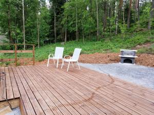 two chairs and a table on a wooden deck at ChillOut GuestHouse Lahti in Lahti
