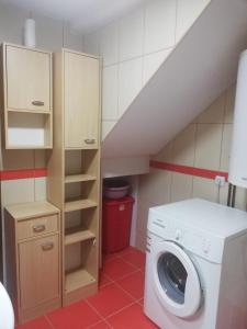 a laundry room with a washer and a staircase at Apartments Šćepanović in Kolašin