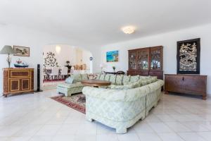 a living room with a couch and a table at Top Cliff Villa with ocean view and pool at stunning cliffs in Burgau
