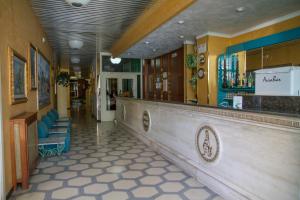a bar in a restaurant with a counter and chairs at HOTEL ATENA in Cirò Marina