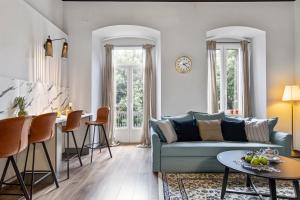a living room with a blue couch and a table at Apartments Carpathia in Rijeka