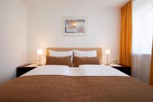 Postel nebo postele na pokoji v ubytování Hotel Garni Tannleger B&B