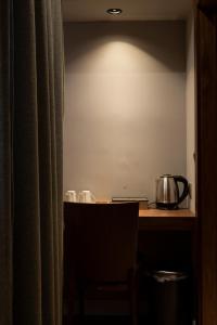 a kitchen with a table with a pot on a counter at Boulevard Center 92 in Pristina