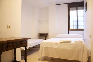Postel nebo postele na pokoji v ubytování Hostal Bocanegra