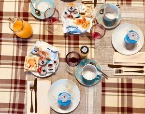 a table with plates of food and glasses of wine at LOCANDA VECCHIA FATTORIA in Monserrato