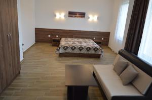 a hotel room with a bed and a couch at SummerHouse Lozenets in Lozenets