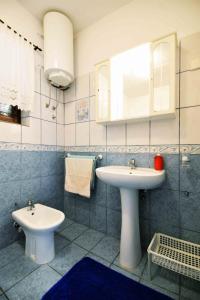 a bathroom with a white sink and a toilet at Apartment Zena in Murter +60 photos