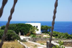 a building on a hill with the ocean in the background at Sunset Villa II in Nea Cryssi Akti