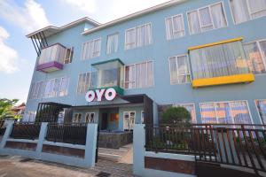 a building with the ovo sign in front of it at OYO 1097 Appartel Cempaka in Pontianak