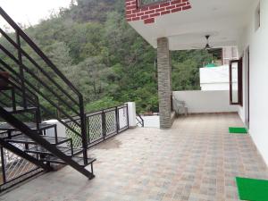 a view from the balcony of a house with stairs at The White House in Rishīkesh