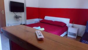 a remote control sitting on a table in a bedroom at room&4you in Supetar