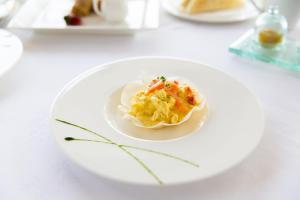 a white plate of food on a table at AVANTI Lifestyle Hotel - Only Adults in Corralejo