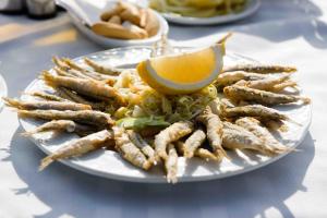 a plate of food with a lemon on it at AVANTI Lifestyle Hotel - Only Adults in Corralejo