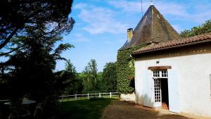 an old white building with a roof at La Jouissiere in Soulignac +11 photos