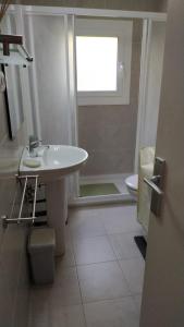 a bathroom with a sink and a toilet and a window at PARADIS TOSSA in Tossa de Mar