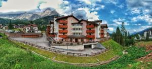 a large building with a view of a mountain range at Residence Pez Gajard in San Martino di Castrozza