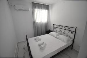 Postel nebo postele na pokoji v ubytování Anesis Apartment