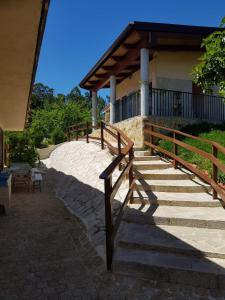 a set of stairs leading to a building with a wooden railing at O Refuxio de la Jerezana in Redondela