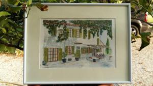 
a painting of a house with a picture of a cat on it at Le Mas Saint Jacques in Le Pontet
