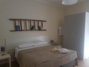 a bedroom with a bed and a shelf on the wall at Affittacamere La Scala in Lecco