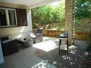 a patio with two chairs and a table at Apartments Maja 221 in Pula