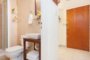 ein Badezimmer mit Toilette, Waschbecken und Spiegel in der Unterkunft 4 Aparts en el mismo edificio, excelente ubicación in Buenos Aires + 124 Fotos