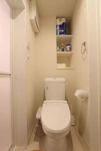 a small bathroom with a white toilet and shelves at Building A101 / Vacation STAY 1275 in Tokyo