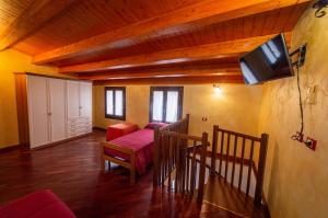 a living room with a couch and a tv in a room at Clelia Case Centro Storico in Ustica