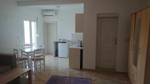 salon z kuchnią i stołem z krzesłami w obiekcie Luce di Sole Apartment w Ulcinju