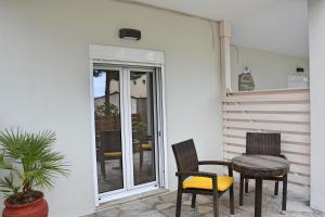 a patio with two chairs and a table on a porch at Mokos Rooms in Perdika