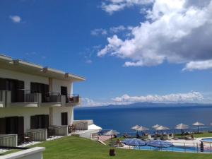 a view of the ocean from the balcony of a hotel at Aegean Blue Studios in Afitos