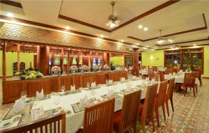 a dining room with a long table and chairs at Royal Crown Hotel & Spa in Siem Reap