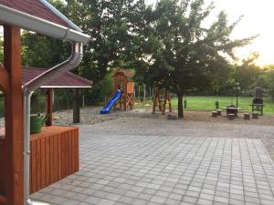 a park with a playground with a slide at Alföldi Levendula Vendégház in Cserkeszőlő