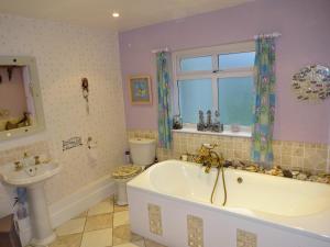a bathroom with a tub and a toilet and a sink at Victorian Gate House Own Bathroom in Solihull