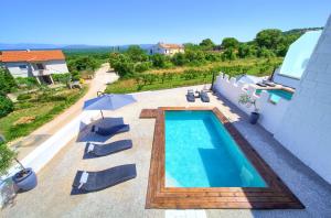a swimming pool on top of a house at Pax Houses in Krk