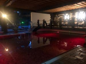 a house with a swimming pool at night at Hotel & Gastropark Loemühle in Marl